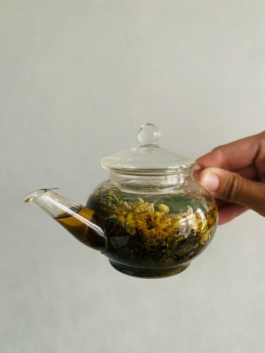 grounding-herbs-in-glass-teapot